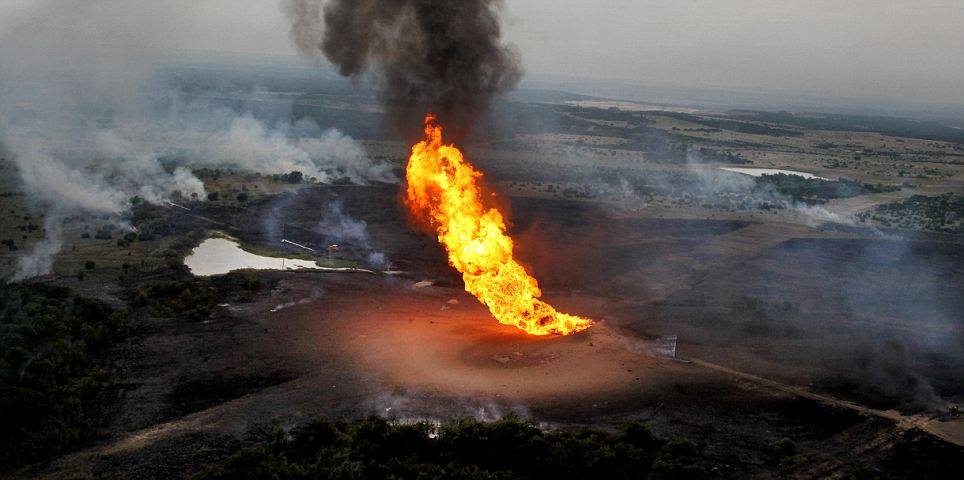 Flames shoot into the air after a natural gas line exploded in Cleburne, Texas, Monday, June 7, 2010.   (AP Photo/The Dallas Morning News, Courtney Perry)