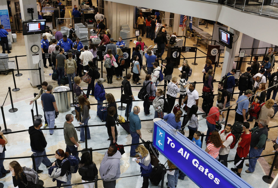 Passengers wait in a security line a day before the annual Thanksgiving Day holiday at the Salt Lake City international airport.