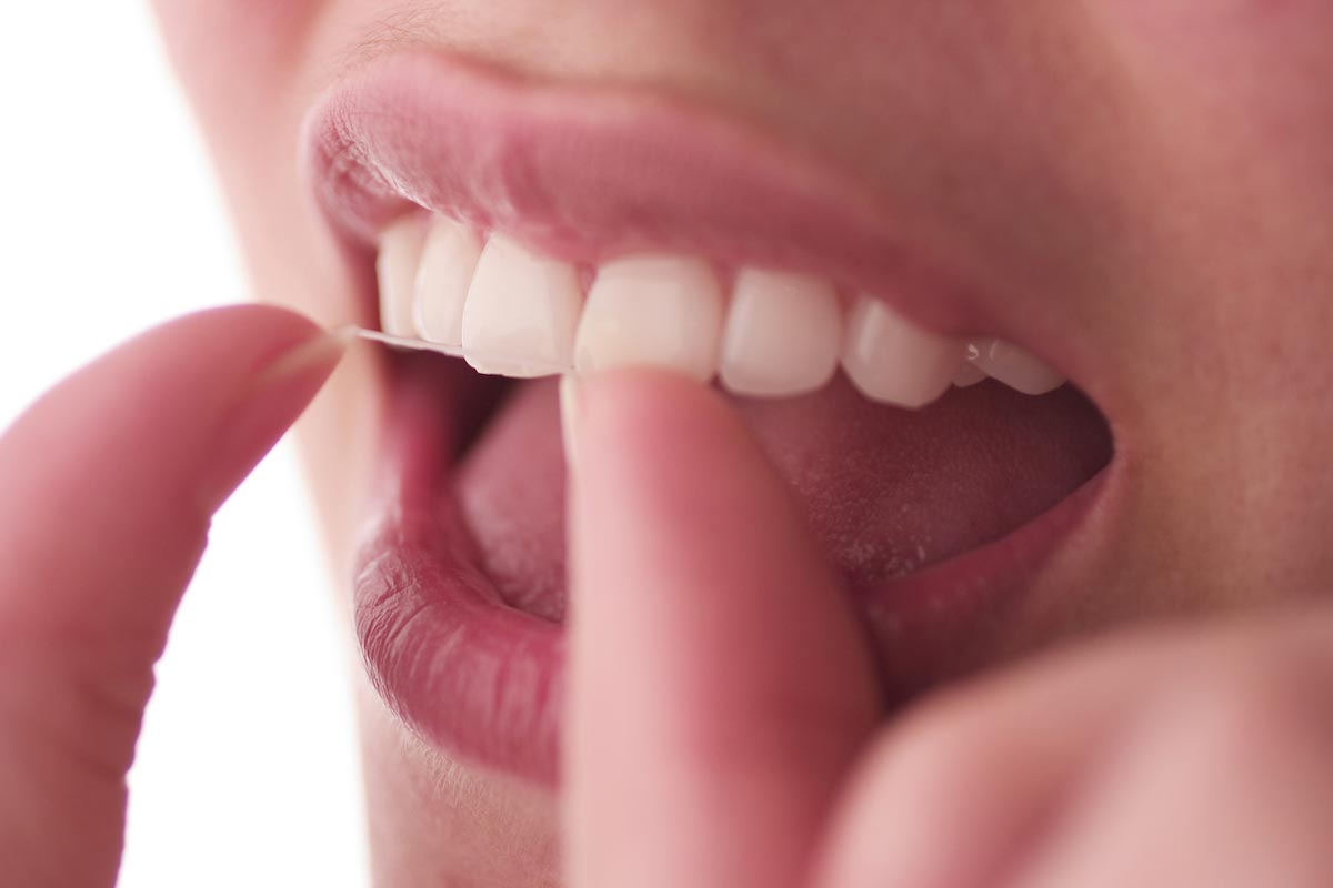 Woman-Floss-Teeth-Close-up