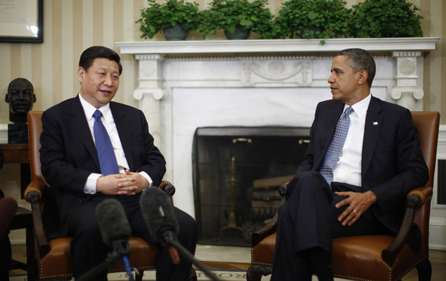 U.S. President Barack Obama (R) listens to China's Vice President Xi Jinping during their meeting in the Oval Office of the White House in Washington, February 14, 2012. Obama and Xi will hold talks on Tuesday that could help boost the international stature of China's leader-in-waiting while testing Obama's ability to balance U.S.-China diplomacy with election-year pressures. REUTERS/Jason Reed (UNITED STATES - Tags: POLITICS) - RTR2XUHB