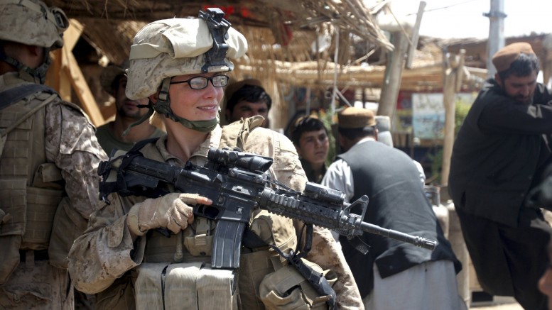 U.S. Marine Lance Cpl. Stephanie Robertson, a member of the female engagement team, speaks with local civilians during a 2010 engagement mission in Marjah, Afghanistan. For centuries men have formed a band of brothers as they faced the enemy on the field of battle, but now in the U.S., military women will soon be on the battlefield, too. (CNS photo/Lance Cpl. Marionne T. Mangrum, U.S. Marine Corps handout via Reuters) (Feb. 26, 2013) See COMBAT-WOMEN Feb. 26, 2013.