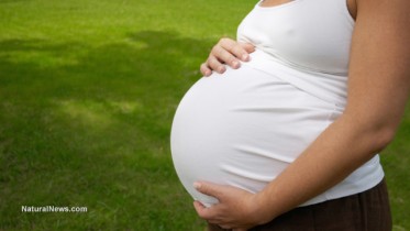 Pregnant-Woman-Caressing-Her-Huge-Belly-At-Open-Air